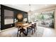Bright dining room with modern decor, wood table, and access to outdoor patio at 2750 Evolutionary Ln, Las Vegas, NV 89138