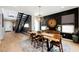 Dining area showcases a wooden table, modern decor, and stairway to the second floor at 2750 Evolutionary Ln, Las Vegas, NV 89138