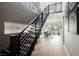 Modern entryway features wood floors, striking staircase, and open layout with plenty of natural light at 2750 Evolutionary Ln, Las Vegas, NV 89138