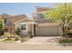 Contemporary home with a well-manicured lawn, modern landscaping and a spacious two-car garage at 2750 Evolutionary Ln, Las Vegas, NV 89138