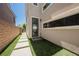 Modern home exterior with well-maintained landscaping and a private side entrance at 2750 Evolutionary Ln, Las Vegas, NV 89138