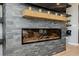 Close up of a modern fireplace set into a stone accent wall in the living room at 2750 Evolutionary Ln, Las Vegas, NV 89138