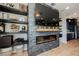 Living room showcasing built-in shelving and an electric fireplace feature wall with a mounted television at 2750 Evolutionary Ln, Las Vegas, NV 89138