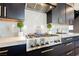 Modern kitchen features stainless steel Zline range, custom cabinets, white countertops, and honeycomb tile backsplash at 2750 Evolutionary Ln, Las Vegas, NV 89138