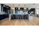Kitchen with custom cabinetry, large island, stainless steel appliances, and modern pendant lighting at 2750 Evolutionary Ln, Las Vegas, NV 89138