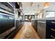 Gourmet kitchen boasts stainless appliances, custom cabinets and hardware, and adjacent dining area at 2750 Evolutionary Ln, Las Vegas, NV 89138