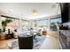 Open floor plan living room with hardwood floors, fireplace, large windows, and designer decor at 2750 Evolutionary Ln, Las Vegas, NV 89138
