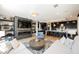 Bright living room with fireplace, shelving, and open access to an island kitchen with bar stool seating at 2750 Evolutionary Ln, Las Vegas, NV 89138