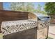 Outdoor kitchen featuring a built-in grill with custom tile countertop, perfect for outdoor cooking and entertaining at 2750 Evolutionary Ln, Las Vegas, NV 89138
