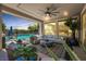Covered outdoor patio area with comfortable seating, a view of the pool, and a ceiling fan at 2750 Evolutionary Ln, Las Vegas, NV 89138