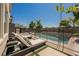 A resort style pool surrounded by lounge chairs and mature landscaping for ultimate relaxation and privacy at 2750 Evolutionary Ln, Las Vegas, NV 89138