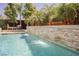 Beautiful pool featuring a stone waterfall and lush landscaping, perfect for outdoor relaxation at 2750 Evolutionary Ln, Las Vegas, NV 89138