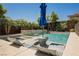 Inviting backyard pool and spa surrounded by lush landscaping offers a private oasis for relaxation and entertainment at 2750 Evolutionary Ln, Las Vegas, NV 89138