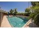 Backyard pool and patio features a waterfall feature, mature trees, and comfortable lounge area, perfect for relaxation at 2750 Evolutionary Ln, Las Vegas, NV 89138