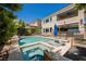 Backyard pool and hot tub, surrounded by lush greenery and comfortable lounge area for relaxation and outdoor entertainment at 2750 Evolutionary Ln, Las Vegas, NV 89138