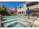 Backyard pool features a modern design with attached spa and lounging area, perfect for relaxation and entertaining at 2750 Evolutionary Ln, Las Vegas, NV 89138