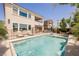 Sparkling backyard pool, covered patio, and lush landscaping provide a serene outdoor living space for relaxation and entertainment at 2750 Evolutionary Ln, Las Vegas, NV 89138