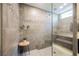 Walk-in shower with stone tiled walls, shower bench, and a glass surround providing a luxurious feel at 2750 Evolutionary Ln, Las Vegas, NV 89138