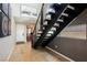 Modern entryway with a striking staircase, wood floors, and contemporary decor at 2750 Evolutionary Ln, Las Vegas, NV 89138