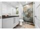 Modern bathroom with stone accent wall in shower, glass door, updated vanity, and neutral color palette at 2820 High Range Dr, Las Vegas, NV 89134