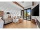 Light and bright bedroom with hardwood floors, wooden beams, and a glass door leading to the backyard at 2820 High Range Dr, Las Vegas, NV 89134