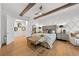 Bright bedroom with wooden beams, a ceiling fan, light-colored hardwood floors, and a diamond pattern accent wall at 2820 High Range Dr, Las Vegas, NV 89134