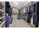 Organized walk-in closet with clothing racks, shelves, drawers, storage boxes, and neutral carpeting at 2820 High Range Dr, Las Vegas, NV 89134