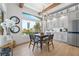 Bright dining area with large windows offering views of the landscaped yard, and a modern chandelier at 2820 High Range Dr, Las Vegas, NV 89134