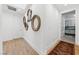 Bright hallway with wood floors, decorative mirrors, and access to the kitchen; clean white baseboards and doors at 2820 High Range Dr, Las Vegas, NV 89134