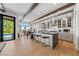 Modern kitchen with an island, stainless steel appliances, and an adjacent dining area with views of the pool at 2820 High Range Dr, Las Vegas, NV 89134