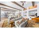 Open concept living area with beamed ceilings, connecting kitchen and dining spaces at 2820 High Range Dr, Las Vegas, NV 89134