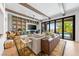 Bright living room with beamed ceilings, custom shelving, and sliding glass doors to the pool at 2820 High Range Dr, Las Vegas, NV 89134