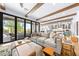 Cozy living room with beamed ceilings, hardwood floors, comfortable seating, and sliding glass doors to patio at 2820 High Range Dr, Las Vegas, NV 89134