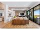 Open living room featuring beamed ceilings, custom shelving, and sliding glass doors at 2820 High Range Dr, Las Vegas, NV 89134