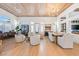 Open-concept living room featuring wood ceiling accents, modern furnishings, and seamless transition to the dining area at 2820 High Range Dr, Las Vegas, NV 89134