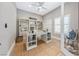 Stylish office with a ceiling fan, custom built-in shelving, a glass-top desk, and jute rug for a professional workspace at 2820 High Range Dr, Las Vegas, NV 89134