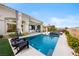 Private pool area with comfortable seating and lush landscaping at 2820 High Range Dr, Las Vegas, NV 89134