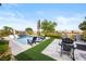 Serene pool and spa area with stylish lounge chairs and landscaping at 2820 High Range Dr, Las Vegas, NV 89134