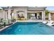 Inviting pool with stylish lounge chairs and seamless indoor-outdoor living space at 2820 High Range Dr, Las Vegas, NV 89134