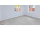 Bright bedroom featuring white walls and wood-look flooring with views to the backyard at 3008 Lawndale St, Las Vegas, NV 89121