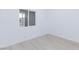 Bright bedroom featuring white walls and wood-look flooring with views to the backyard at 3008 Lawndale St, Las Vegas, NV 89121