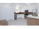 Bright kitchen featuring stainless steel appliances, white cabinetry, and modern lighting fixtures at 3008 Lawndale St, Las Vegas, NV 89121