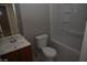 Bathroom featuring vanity with sink, toilet and tub with white tile at 3101 E Carey Ave, North Las Vegas, NV 89030