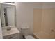 The bathroom features a large mirror over the sink and a bathtub with light beige wall panels at 3101 E Carey Ave, North Las Vegas, NV 89030