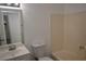 The bathroom features a large mirror over the sink and a bathtub with light beige wall panels at 3101 E Carey Ave, North Las Vegas, NV 89030