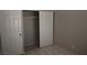 A bedroom features tile floors, neutral paint, and a closet with sliding doors at 3101 E Carey Ave, North Las Vegas, NV 89030