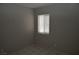 This bedroom features tile flooring and a window with blinds at 3101 E Carey Ave, North Las Vegas, NV 89030
