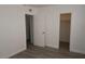 Bright bedroom featuring new laminate flooring, freshly painted walls, and doors to closet and hallway at 3101 E Carey Ave, North Las Vegas, NV 89030