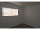 Light-filled bedroom with window, fresh paint, and new laminate flooring at 3101 E Carey Ave, North Las Vegas, NV 89030