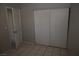 Cozy bedroom with neutral walls, tile flooring, and a closet with sliding doors at 3101 E Carey Ave, North Las Vegas, NV 89030
